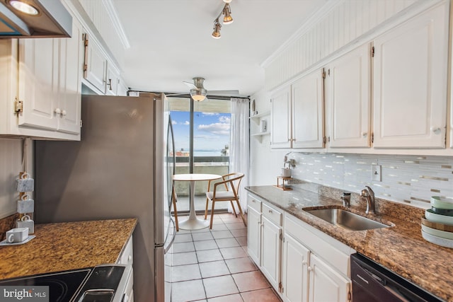 kitchen with decorative backsplash, white cabinets, a sink, dark stone counters, and dishwasher