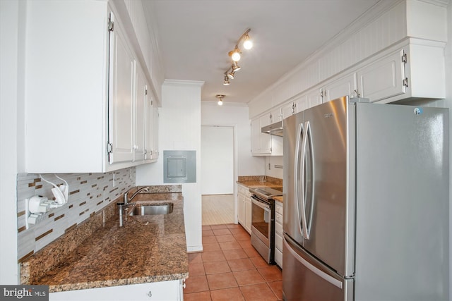 kitchen with appliances with stainless steel finishes, dark stone counters, white cabinetry, and a sink