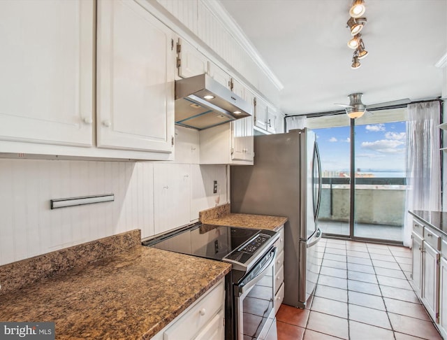 kitchen featuring range hood, ornamental molding, white cabinets, stainless steel range with electric stovetop, and dark stone counters