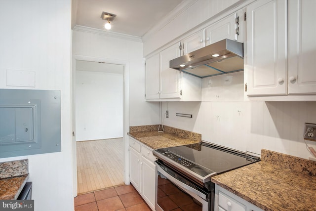 kitchen with electric range, electric panel, ornamental molding, under cabinet range hood, and white cabinetry