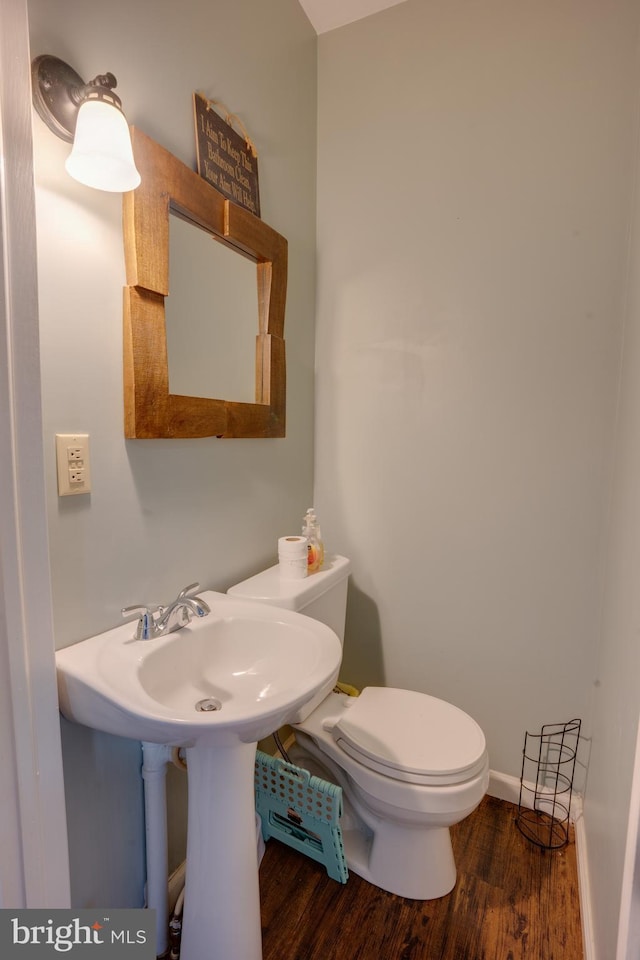 bathroom featuring hardwood / wood-style floors and toilet