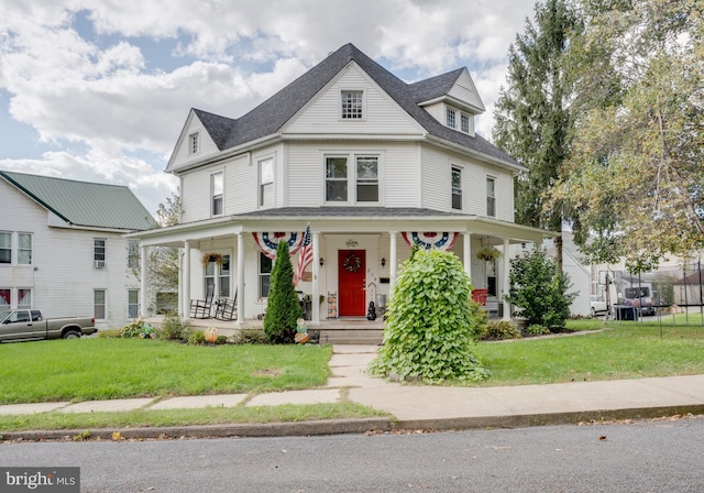 view of front of house with covered porch and a front yard