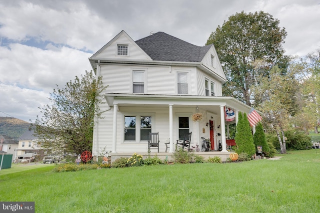 view of front facade with covered porch and a front lawn