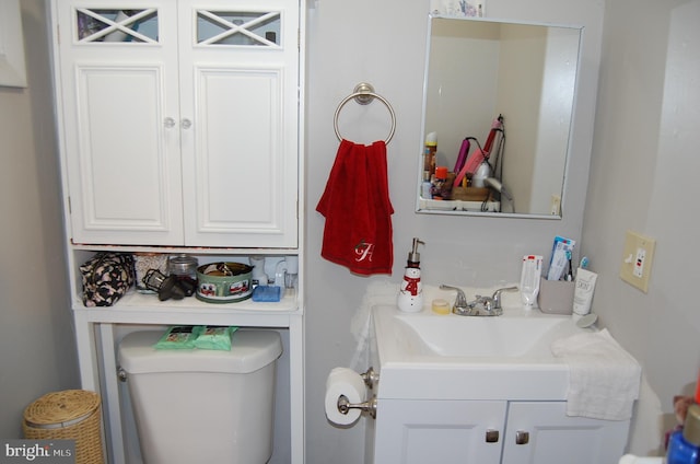 bathroom featuring vanity and toilet