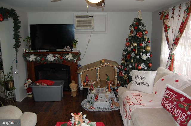 living room featuring dark hardwood / wood-style floors, ceiling fan, and a wall mounted AC