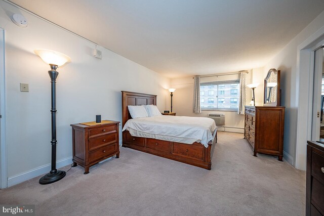 bedroom featuring a wall mounted AC and light colored carpet