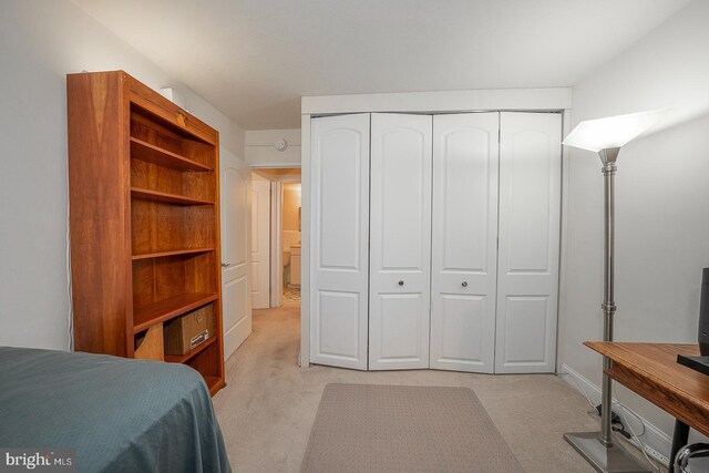 carpeted bedroom featuring a closet