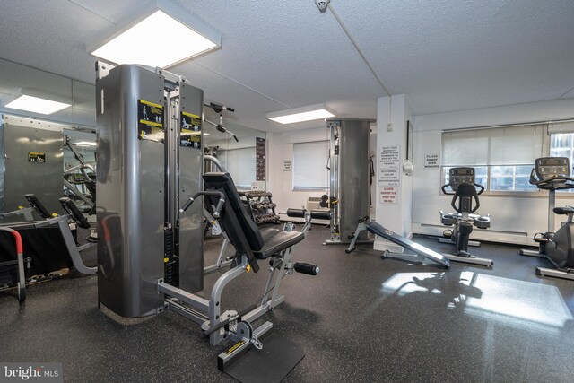 exercise room with a textured ceiling