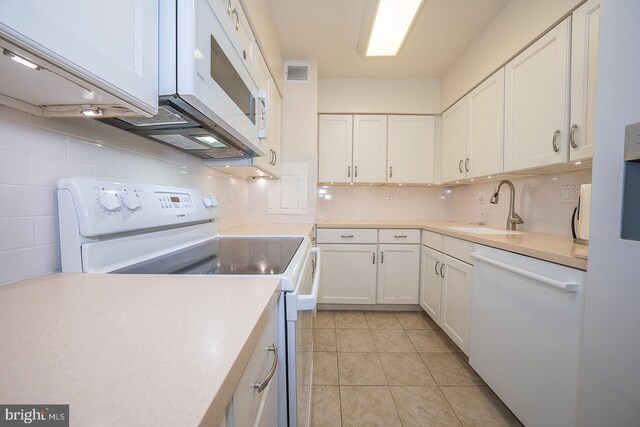 kitchen featuring white cabinets, decorative backsplash, white appliances, and sink