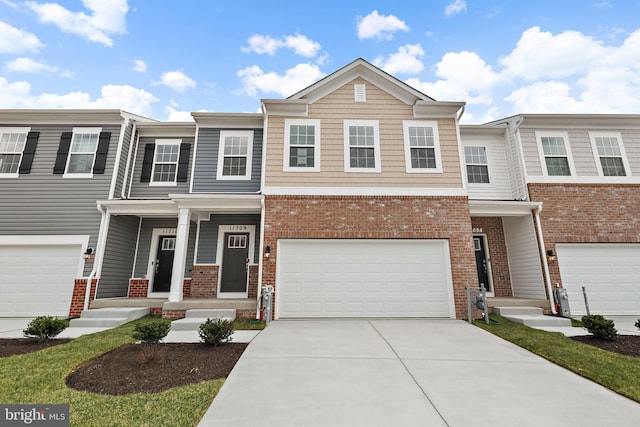 townhome / multi-family property with a garage and covered porch