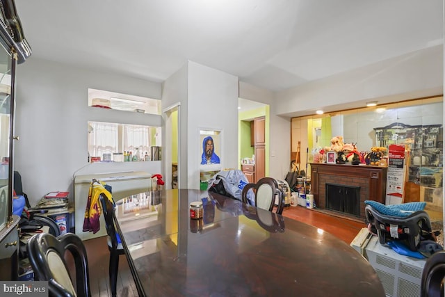 dining room with a fireplace and wood-type flooring