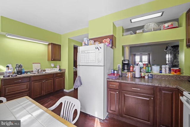 kitchen featuring white appliances, sink, and dark hardwood / wood-style flooring