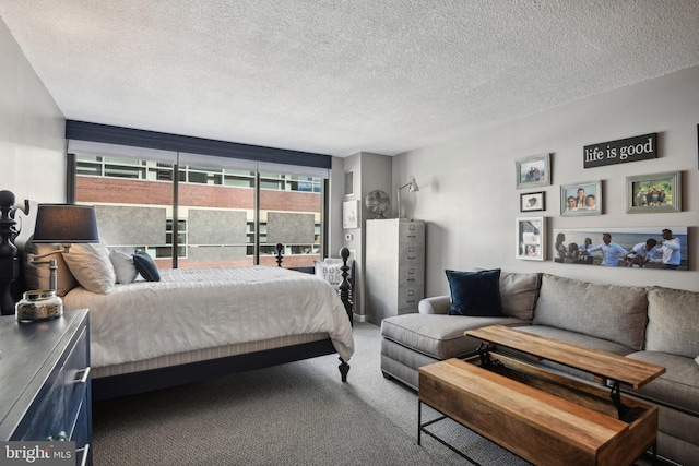 bedroom with carpet floors and a textured ceiling