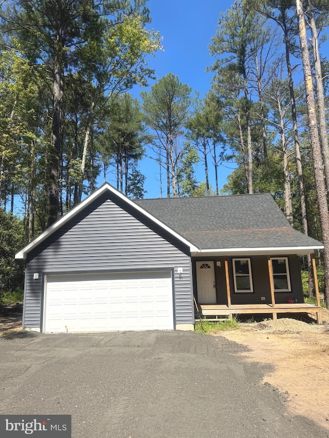 view of front of house featuring a porch and a garage