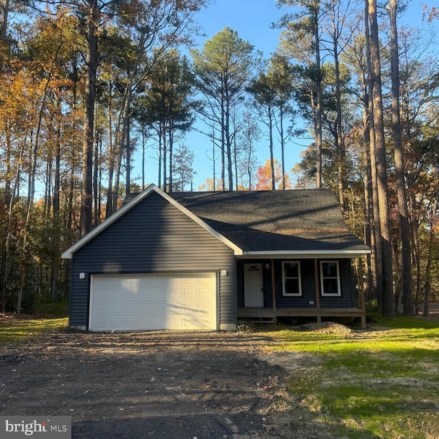 single story home featuring covered porch and a garage