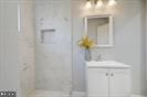 bathroom with a shower and vanity