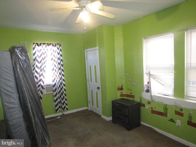 misc room with dark carpet and ceiling fan