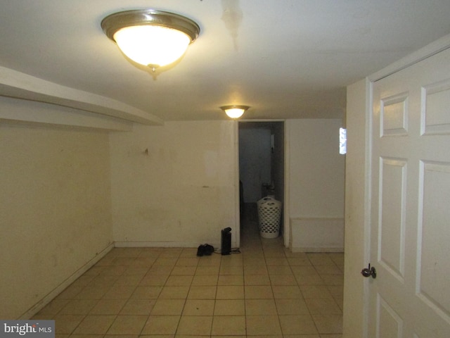 basement featuring light tile patterned flooring