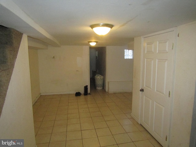 basement with light tile patterned flooring