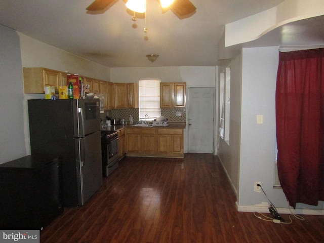 kitchen featuring stainless steel refrigerator, ceiling fan, dark hardwood / wood-style floors, backsplash, and stove