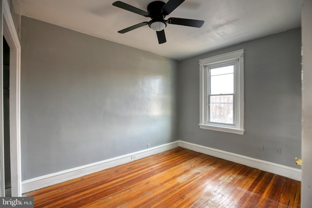 spare room with ceiling fan and hardwood / wood-style flooring