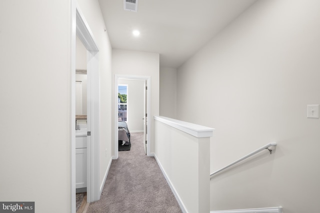 corridor featuring light colored carpet