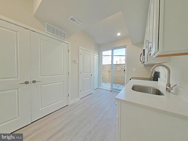 kitchen featuring light wood-type flooring and sink