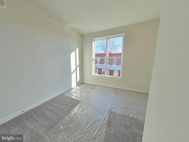 spare room featuring light carpet