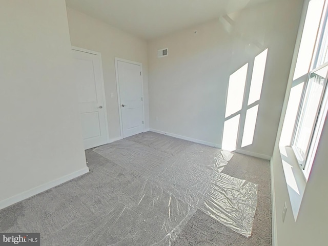 empty room with light colored carpet