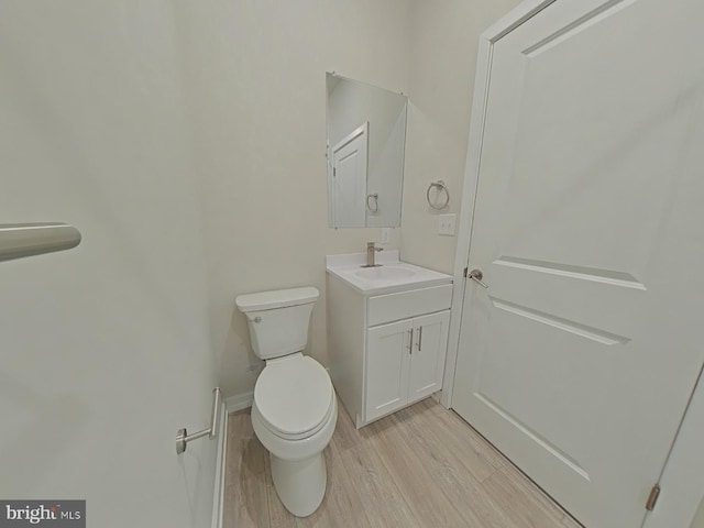 bathroom featuring vanity, toilet, and wood-type flooring