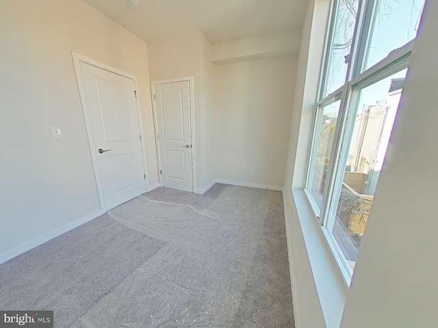 carpeted empty room with plenty of natural light