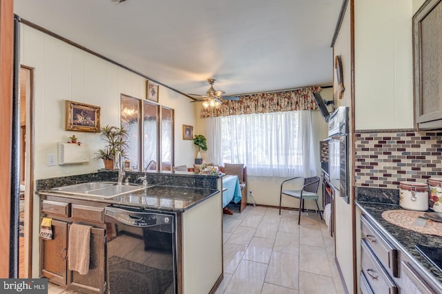 kitchen featuring decorative backsplash, ceiling fan, sink, black appliances, and dark stone countertops