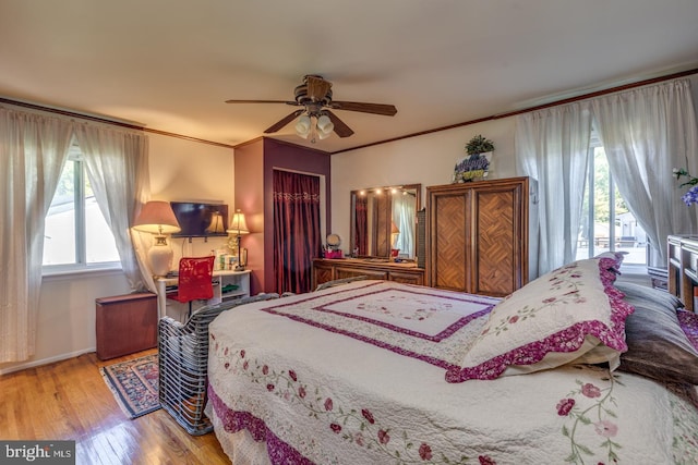 bedroom with access to exterior, ceiling fan, ornamental molding, and light wood-type flooring