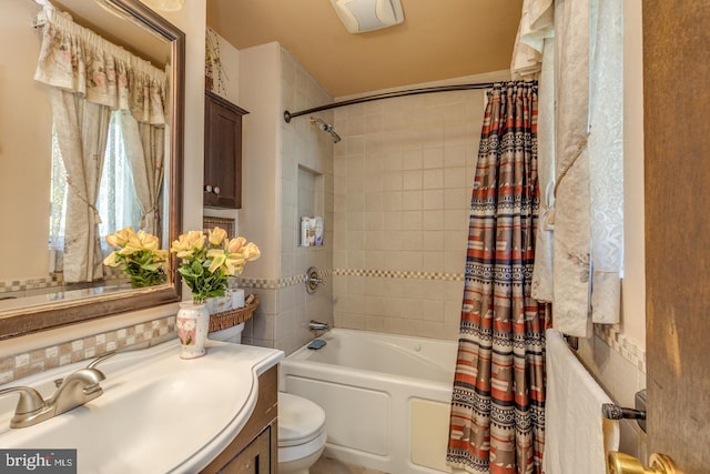 full bathroom with vanity, toilet, and shower / bath combo with shower curtain