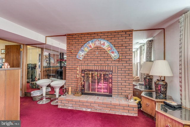 carpeted living room with a brick fireplace