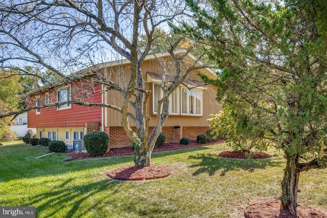 view of home's exterior with a yard