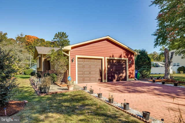 view of front of home with a garage and a front lawn