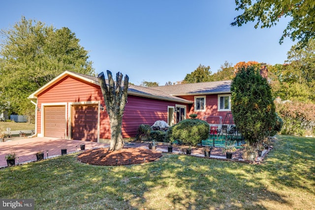 view of front of home with a garage and a front yard