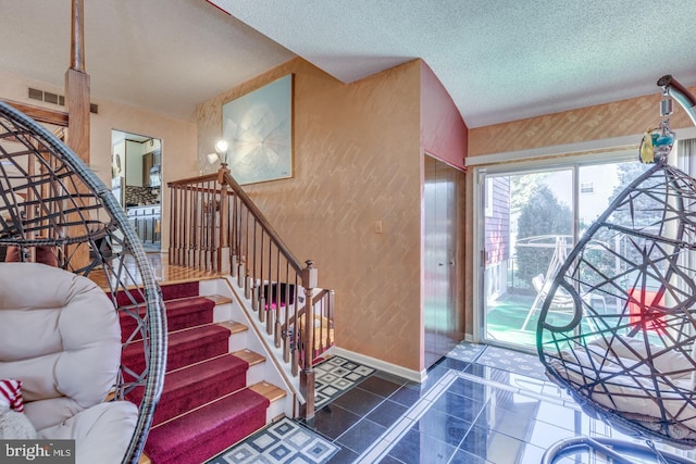 entryway with a textured ceiling