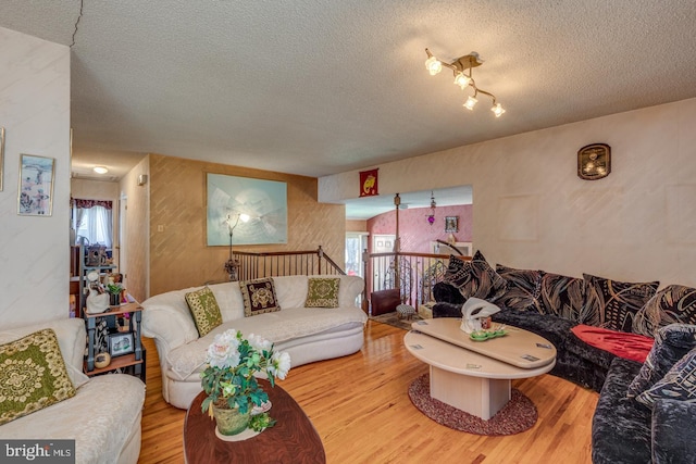 living room featuring hardwood / wood-style floors and a textured ceiling