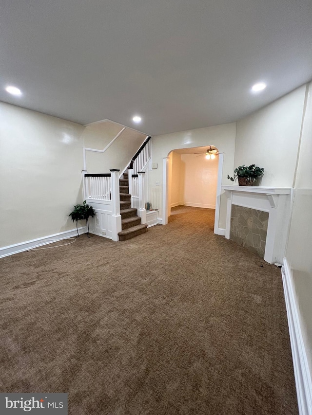 basement featuring ceiling fan and carpet floors