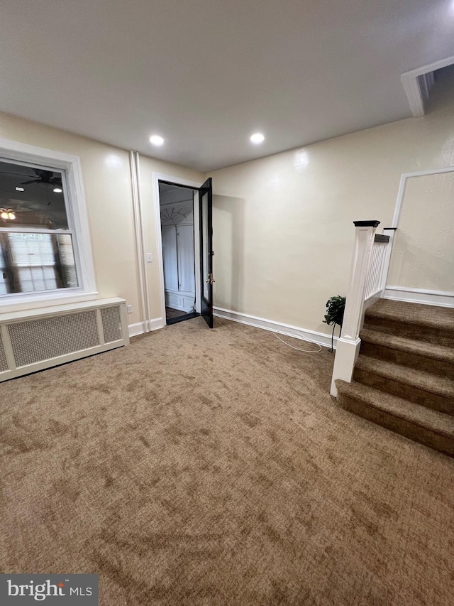 basement featuring radiator and carpet floors