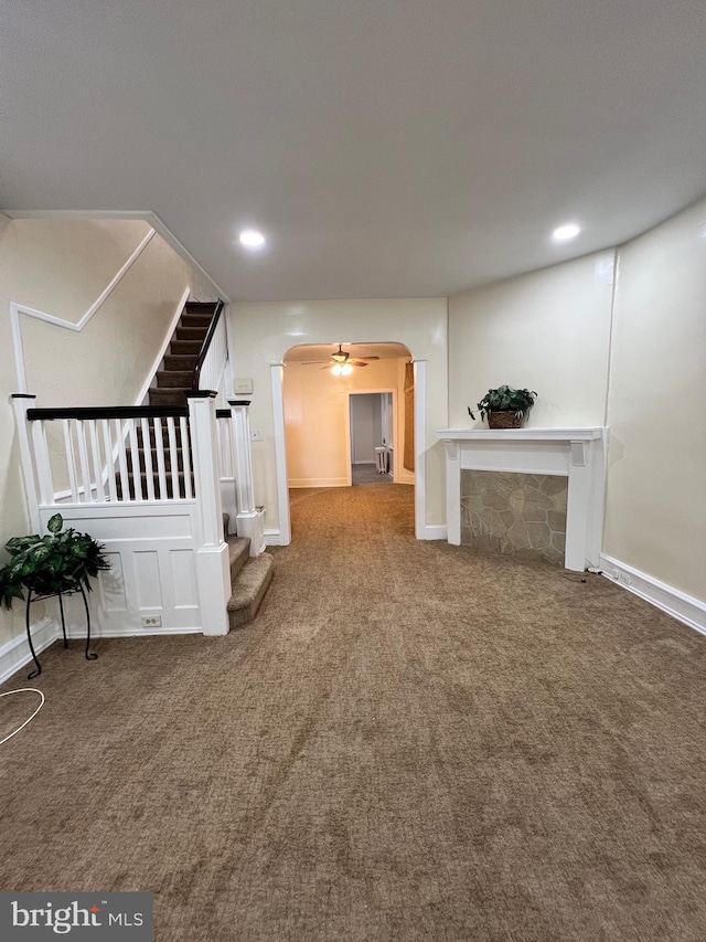 interior space with ceiling fan and carpet floors