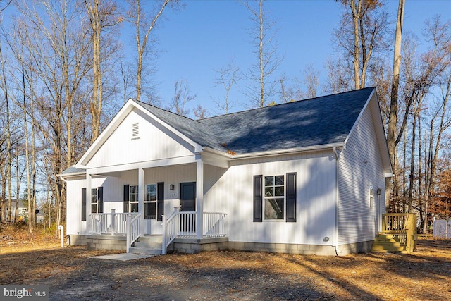 view of front of house with covered porch and a shingled roof