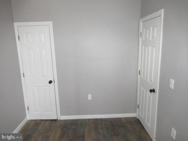 spare room featuring dark wood-type flooring