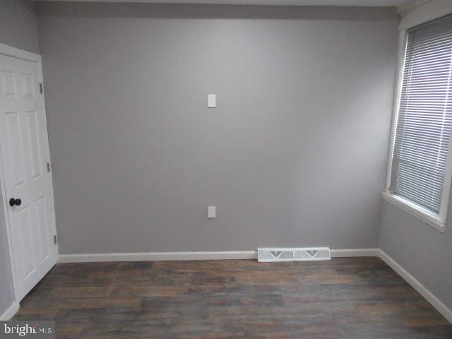 spare room with dark hardwood / wood-style flooring