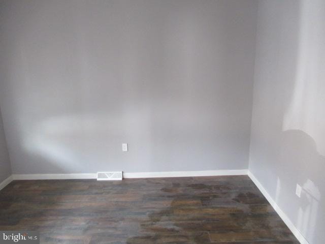 empty room featuring dark hardwood / wood-style flooring