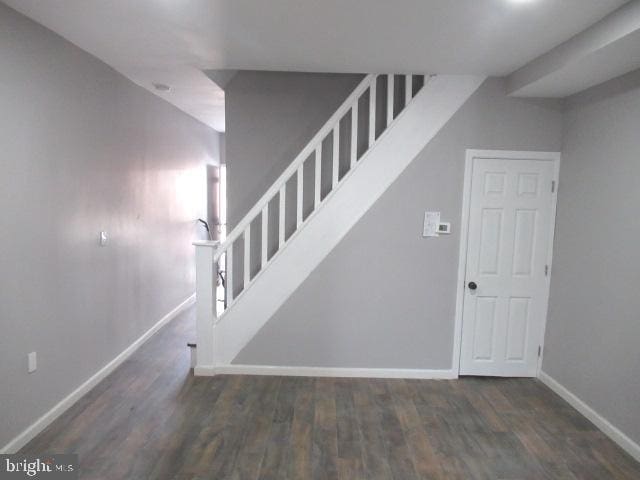 staircase with hardwood / wood-style floors