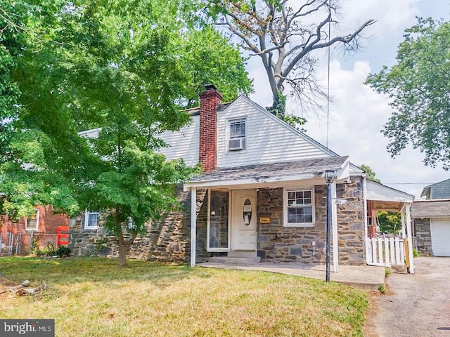 view of front of house with a front lawn, covered porch, and a garage