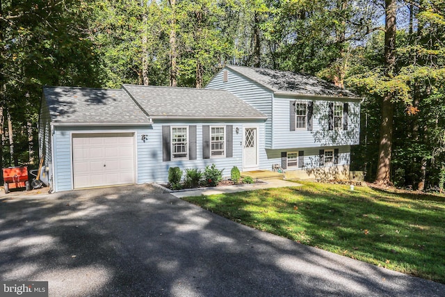 split level home with a porch, a garage, and a front yard